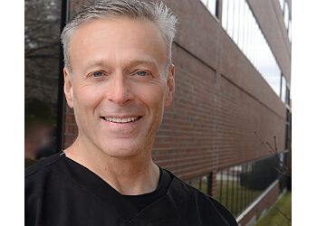 Photo of BRYAN HOERTDOERFER, TREATMENTS OFFERED:Same-day CEREC Restorations (Crowns and Onlays), Routine Hygiene Care for All Ages, Dentures, Partials, Bridges, Fillings and Sealants, Implants, Veneers, Digital X-Rays, Philips Zoom In-Office Teeth Whitening &amp; Invisalign in MANCHESTER