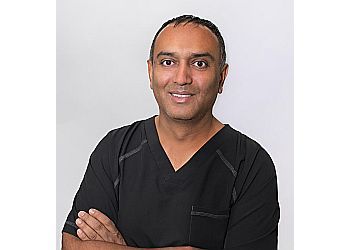 Photo of DR. BHISHMA PATEL, CONDITIONS TREATED: Bunions, High Arch, Stiff Toe Joint, Morton&#x27;s Neuroma, Hammer Toe, Heel Pain, Gout, Ingrown Toe Nail, Pediatric Flat Foot, Pediatric Heel Pain and Nail Fungus TREATMENTS OFFERED: Custom Orthotic Skates, Foot Surgery, Ingrown Toenail Treatment, Shockwave Therapy &amp; Cryosurgery for Wart Treatments in ST. ALBERT