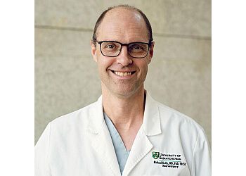 Photo of DR. MICHAEL KELLY, CONDITIONS TREATED:Meningioma Tumour, Macroadenoma, Vascular Compression Syndromes in the Brain, Epilepsy, and Craniovertebral Junction Disorders TREATMENTS OFFERED: Complex Brain, Spine &amp; Trauma Surgeries in SASKATOON