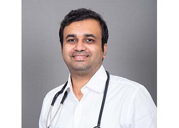 Photo of DR VIJAY SHEKAR P, Implantable Cardioverter Defibrillator, Transesophageal Echocardiogram, Permanent Pacemaker, Balloon Mitral Valvotomy, Arrhythmia Treatments, TAVI, Coronary Angiogram, Primary Angioplasty, Cardiac Resynchronization Therapy, Micra Insertion, Heart Failure Therapies Like Impella, IABP, ASD, VSD, PDA Device Closures, Endovascular Interventions Like Aneurysm Repair, Angioplasty and /Stenting, Right and Left Heart Catheterization, Transcatheter Aortic Valve Replacement (TAVT), Angioplasty, Device Closure, Endovascular Stent Grafting, Peripheral Angiogram/ Angioplasty, Carotid Stenting, Implantable Cardioverter Defibrillator Transesophageal Echocardiogram Permanent Pacemaker, Arrhythmia, Coronary Angiogram &amp; Primary Angioplasty in TIRUCHIRAPPALLI