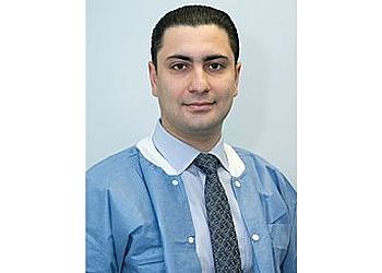 Photo of YULIAN AMINOV, CONDITIONS TREATED:TMJ Disorders, Implant and Pediatric Dental IssuesTREATMENTS OFFERED: CBCT, Ceramic Crowns, CEREC® Crowns, Cosmetic Dentistry, Dental Bridges, Dental Cleanings, Dental Fillings, Dentures, Digital Impressions, Digital Radiography, Emergency Treatment, Oral Cancer Screening, Oral Exams, Periodontal Treatment, Extractions, Implant Restorations, Invisalign®, Night Guards, Preventive Program, Root Canals, Same Day Dentures, Same Day Repairs, Sports Mouthguards, Teeth Whitening &amp; Veneers in BRIDGEPORT